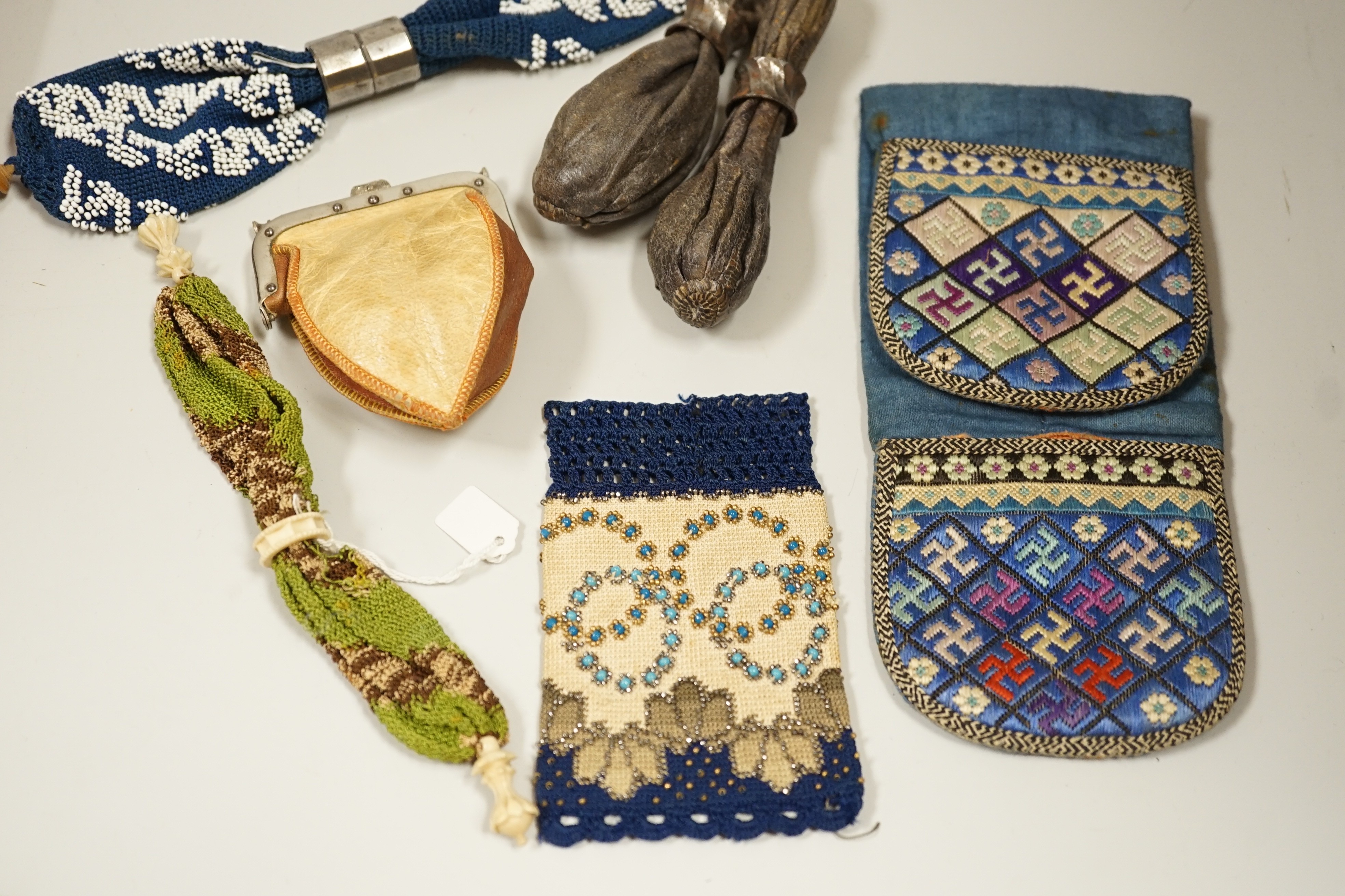 A velvet and metal embroidered reticule possibly 18th century, together with a collection of beaded embroidered knitted and leather purses, bags misers purses and a feather coin purse(14)